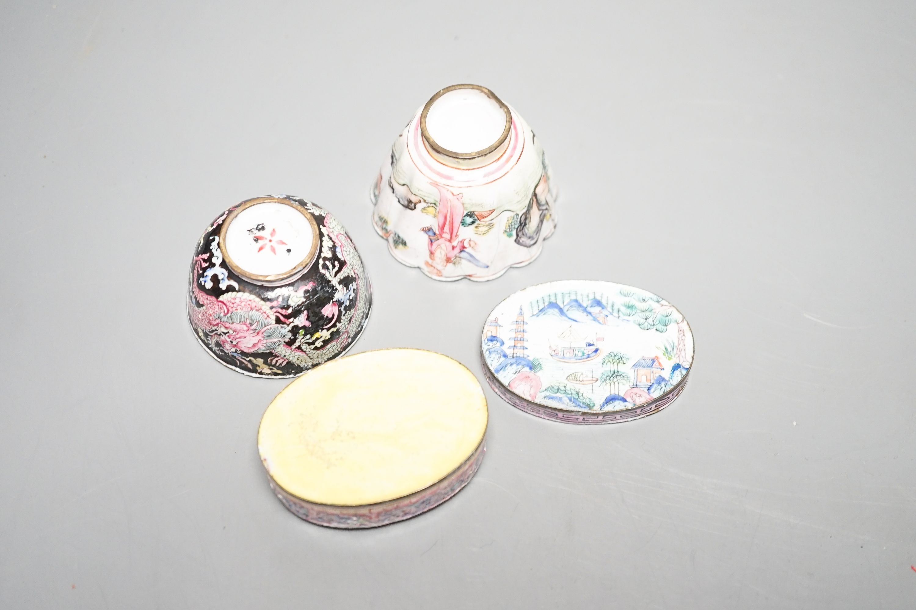 Two 18th century Chinese Canton enamel cups, and a 19th century Canton enamel oval snuff box, 5.8cm